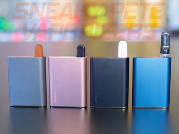 Grey, pink, black and blue Ccell Palm standing on a table next to each other. They all have cartridge inserted.