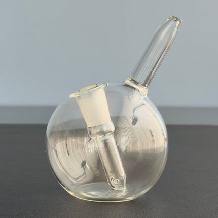 the sneaky Pete hand globe handheld bong sitting on table