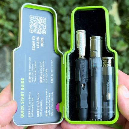 DynaVap B2 full kit inside protective tin case with device, custom DynaTorch lighter, and quick start guide visible.