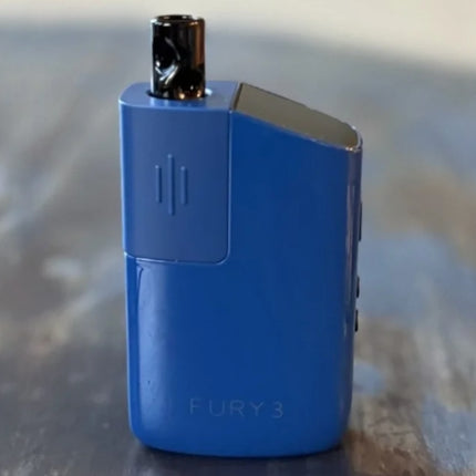 Blue Fury 3 vaporizer standing on a wooden surface, highlighting the smooth texture and discreet form factor.