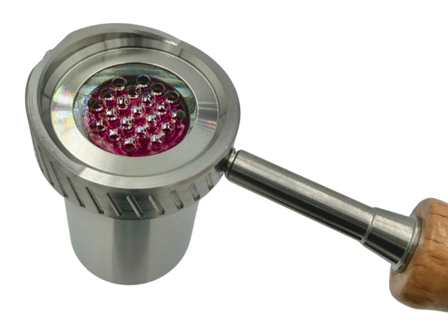 Close-up of Universal Baller quartz-lined heater head showing ruby balls and all-glass air path inside metal housing