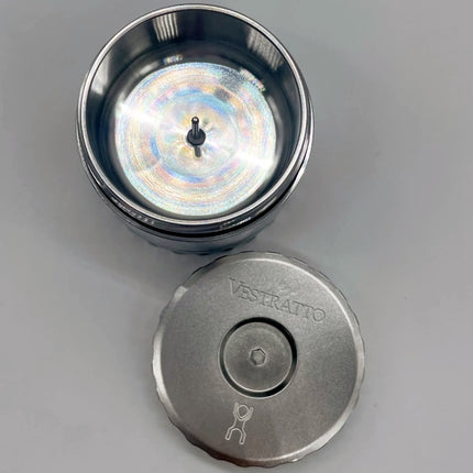 Vestratto Stash open — stainless steel debowler showing interior chamber for herb storage and cooling hot bowls.