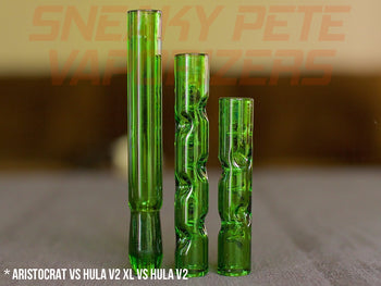 Forest Colored Aristocrat Stems For DynaVap standing on a table next to Forest Hula stem XL and Forest Hula stem.