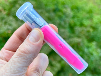 Neon pink Dynavap B Portable Vaporizer in a clear plastic case.
