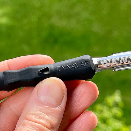 Holding black Dynavap B Portable Vaporizer.