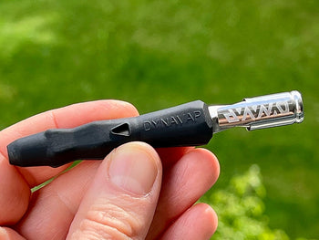 Holding black Dynavap B Portable Vaporizer.