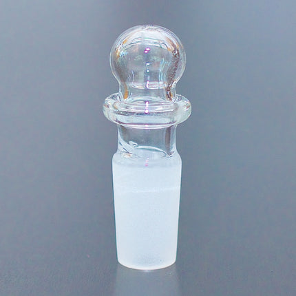 Round top 14mm glass stopper on a table.