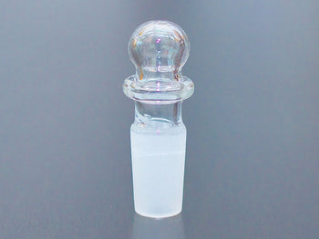 Round top 14mm glass stopper on a table.