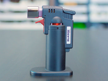 Black Blazer Firefox Butane Torch lighter standing on a table.