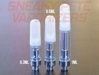 1ml, 0.5ml and 0.3ml white CCell TH2 oil cartridges standing next to each other on a table.