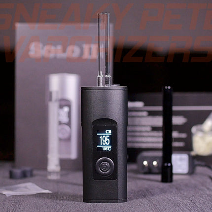 Black Arizer Solo 2 portable dry herb vaporizer with accessories standing on a table. 