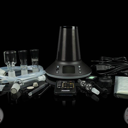 Arizer XQ2 desktop vaporizer on black background with accessories next to it.