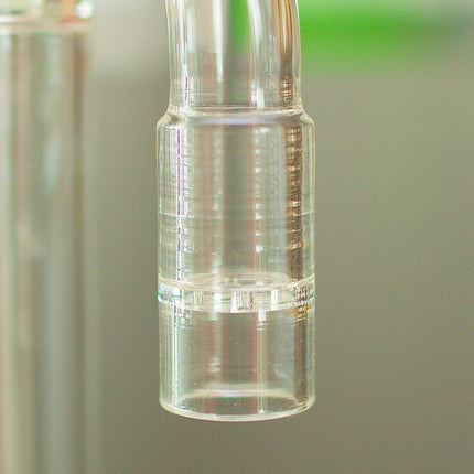 Closeup of a glass stem of Arizer BubbleMax on a table.