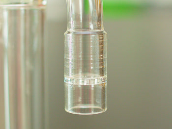 Closeup of a glass stem of Arizer BubbleMax on a table.