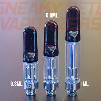 1ml, 0.5ml and 0.3ml black CCell TH2 oil cartridges standing next to each other on a table.