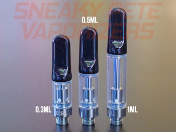 1ml, 0.5ml and 0.3ml black CCell TH2 oil cartridges standing next to each other on a table.