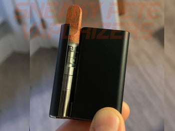 Holding black Ccell Palm with cartridge inserted.