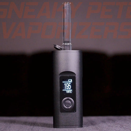 Black Arizer Solo 2 portable dry herb vaporizer with a stem inserted, standing on a table.  