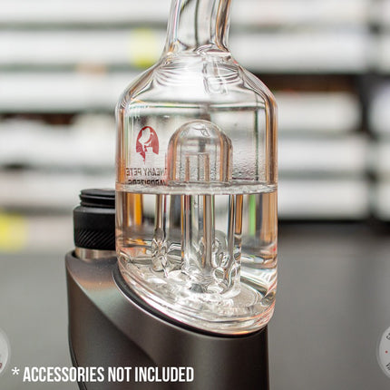 Closeup of Bent-Neck Peak Pro Top glass piece in Puffco Peak Pro standing on a black table.