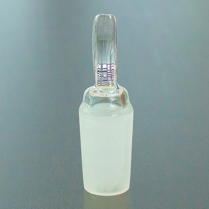 Flat top 14mm glass stopper on a table, side view.