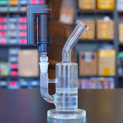 Crafty+/Mighty+ 3-in-1 glass adapter inserted into Crafty+ and a big waterpiece standing on a table.
