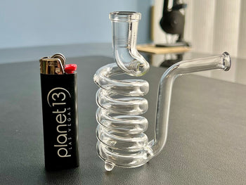 dryspring glass cooling stem next to standard big lighter