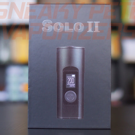 Black Arizer Solo 2 portable dry herb vaporizer box standing on a table.  