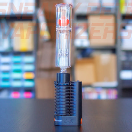 Crafty+/Mighty+ 3-in-1 glass adapter inserted into Crafty+ and a small waterpiece standing on a table.