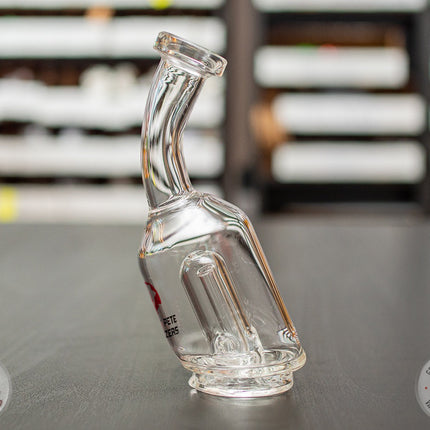 Bent-Neck Peak Pro Top glass piece standing on a black table.