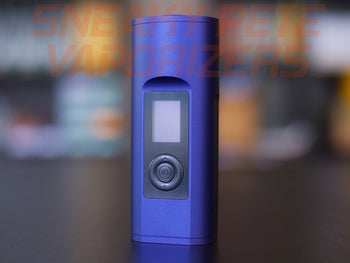 Blue Arizer Solo 2 portable dry herb vaporizer standing on a table. 