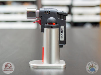 Silver Blazer Firefox Butane Torch lighter standing on a table.