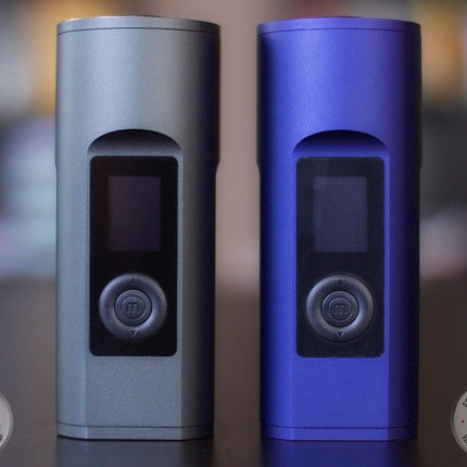 Black and blue Arizer Solo 2 portable dry herb vaporizers standing on a table.